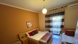 A compact room with a bed, a desk, and a chair. - Algo Hotel (Tirana)
