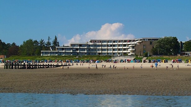 A beach with a building in the background.