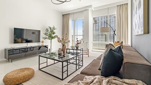 A modern living room with a sofa, coffee table, and TV.