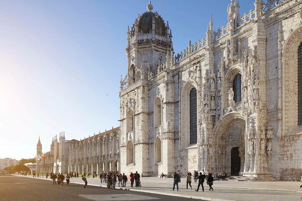 A historic building with intricate stonework and multiple towers.