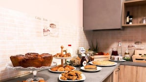 A breakfast buffet with various pastries, sandwiches, and beverages. - B&B VILLA VERONA BIKE (Buttapietra)