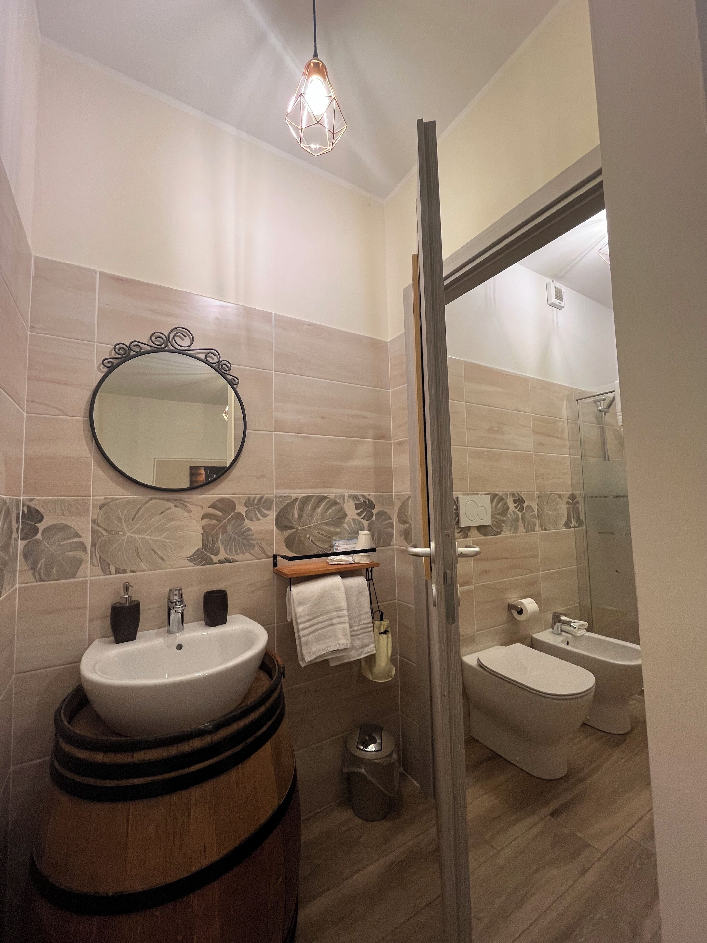 A bathroom with a sink, mirror, and toilet.