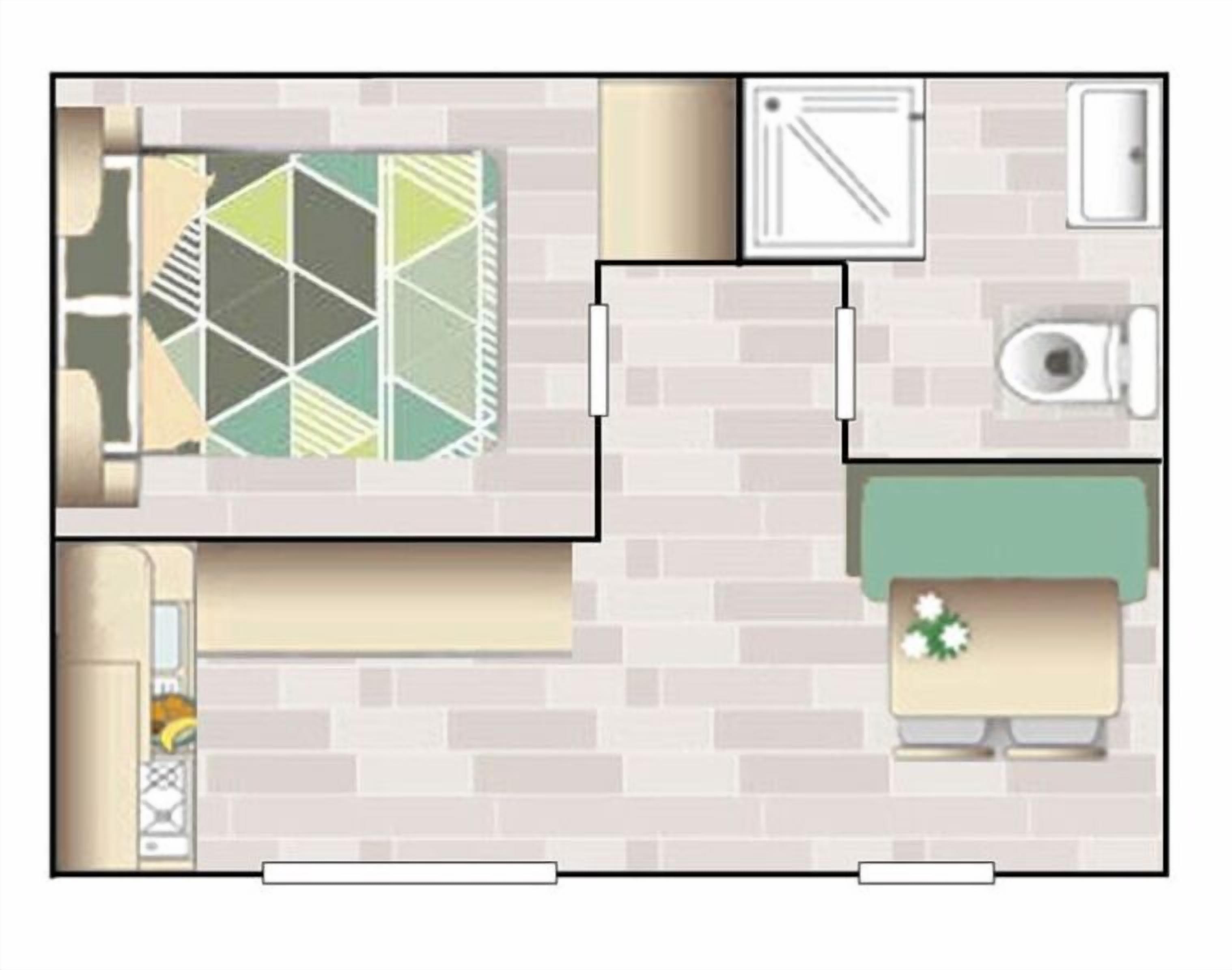A top-down view of a hotel room with a kitchen area, a bathroom, and a seating area with a green sofa.