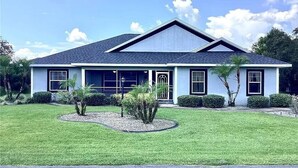 A single-story house with a gabled roof, a front porch, and a well-maintained lawn.