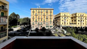 A multi-story building with a central entrance, balconies, and a clear sky. - Oasi d'Oltremare (Naples)