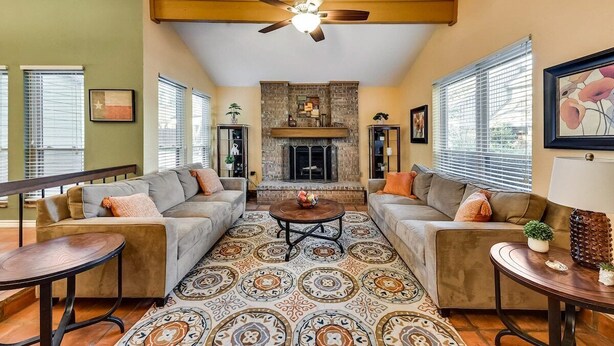 A living room with a fireplace, two sofas, a coffee table, and a patterned rug. - Willow Bend: 4-Bedroom Tranquil Escape (Bedford)