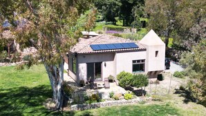 A single-story house with a tiled roof and a small attached garage. - Guesthouse in very private location in Malibu with ocean views!
 (Malibu)