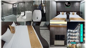 A hotel room with a modern bathroom, a bed with a unique headboard, and a view of the hotel exterior. - palermohotel  (Hanoi)