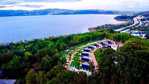 An aerial view of a resort with multiple buildings, a swimming pool, and a view of the lake. - Lake Look Sapanca (Sapanca)