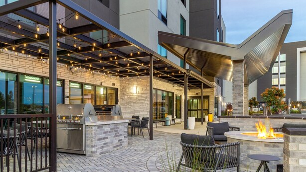 An outdoor patio area with a grill, seating, and a fire pit. - TownePlace Suites by Marriott Pleasanton (Pleasanton)