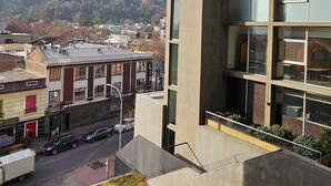 A modern building with large windows and a view of a hilly landscape. - Dardigniac (Santiago)