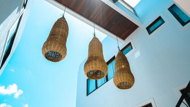A modern building with three hanging wicker lamps. - Zenhousepipa (Tibau do Sul)