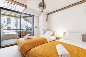 A hotel room with two beds, a balcony, a large window, and a ceiling light. - A short stroll to Palais/Beach, Terrace & Seaview (Cannes)