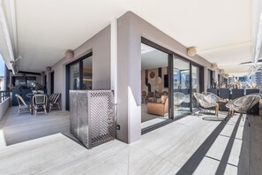 A modern interior with a dining area, seating, and a view through a glass door. - A short stroll to Palais/Beach, Terrace & Seaview (Cannes)