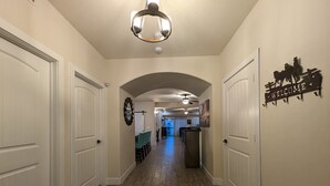 A hallway with white doors, a ceiling fan, and a welcome sign with horses. - The Hideout is a recently remodeled, fully wheelchair-accessible, luxury condo  (St. George)