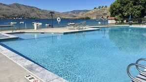 A clear blue pool with a lifeguard chair, lounge chairs, and a 30 ft depth marker. - Lakefront Studio Condo~Step into the Lake at Spader Bay (Chelan)