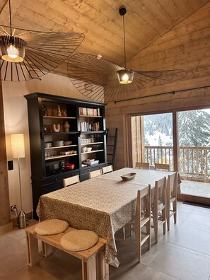 Enjoy meals in this inviting dining area with a beautifully set table, buffet, and comfortable seating.