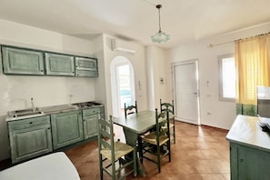 Interior - Two-room apartment with 3 beds, 42/48 m2: living room with kitchenette and single sofa bed (length 190 cm), double bedroom (separable beds) and a bathroom.All apartments are arranged on the ground floor or first floor furnished in typical Sardinian style (Orosei)