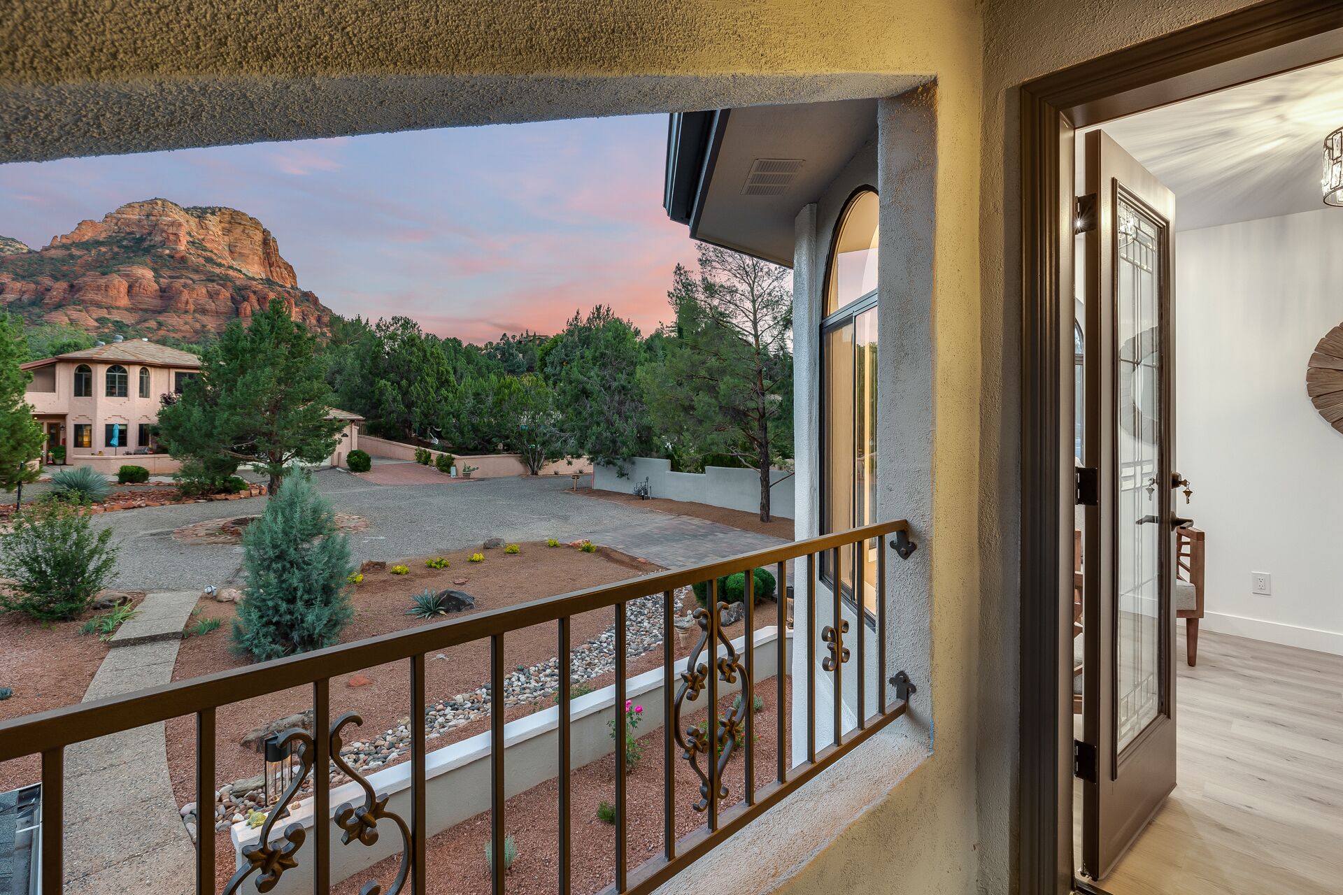 A balcony with a view of a mountain and a building.