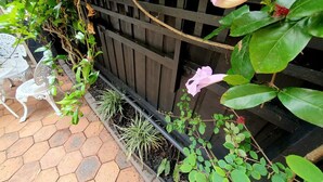A garden area with a wooden fence, potted plants, and a white metal sculpture. - "Villa Magdalena" luxury studio (St Kilda)