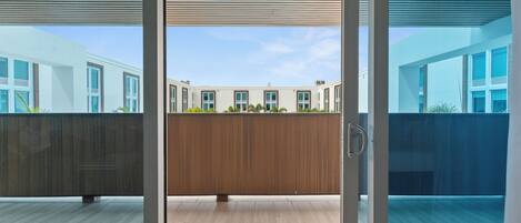 A modern building with large windows and a wooden deck area.