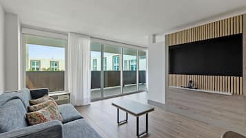 Suite, 1 King Bed with Sofa bed, Balcony | Living area | 55-inch Smart TV with cable channels, Netflix, pay movies