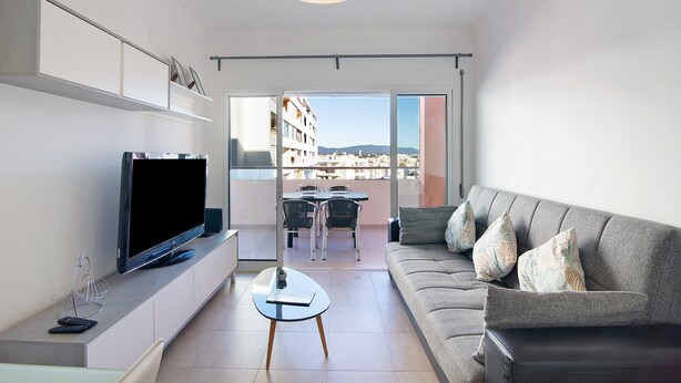 A modern living room with a flat-screen TV, sofa, and coffee table. - Holiday Apartment "Portimão" with Mountain View, Shared Pool & Wi-Fi (Portimão)
