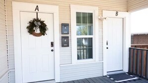 A house with two white doors labeled A and B, a mailbox, and a window with blinds. - Double Everything - Sleeps 13

 (Fort Worth)