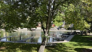 A park with a lake, benches, and a grassy area. - Best Value. Large 2 Bedroom Condo in Bigfork, Montana. Perfect Summer Getaway!  (Bigfork)