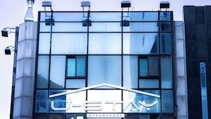 A modern building with a glass facade and a prominent sign reading "U-STAY MYEONGDONG". - U STAY MyeongDong (Seoul)