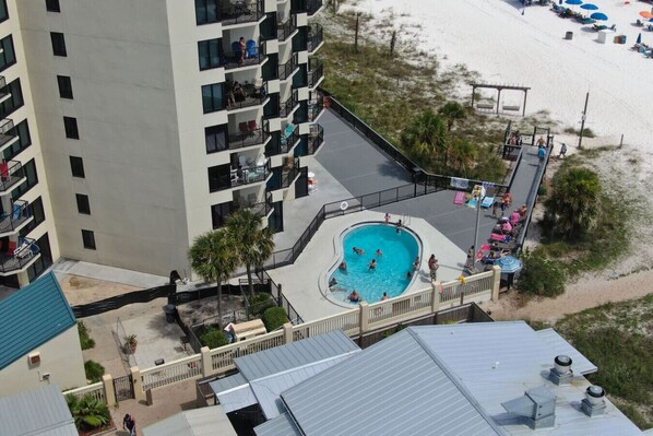 A high-rise hotel with a rooftop pool, a beachside location, and a view of the ocean.