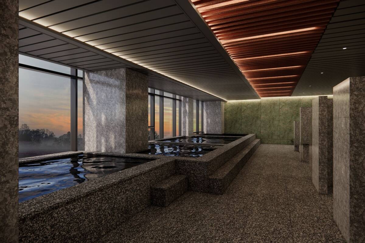 Ein modernes Spa mit einer langen Sitzbank, einem beheizten Pool und Blick auf den Sonnenuntergang durch große Fenster.