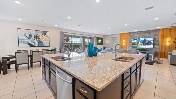 A modern kitchen with granite countertops, stainless steel appliances, and a large island. - Fruit Ninja Arcade, Fast and Furious Racing, Space Bedrooms, Theater, Pool Table: Cosmic Way (Kissimmee)