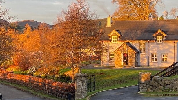 A large stone house with a well-maintained lawn and a stone wall. - Rostrevor Valley 6-Br, Sleeps 20 w/ Hot Tub & View (Rostrevor)