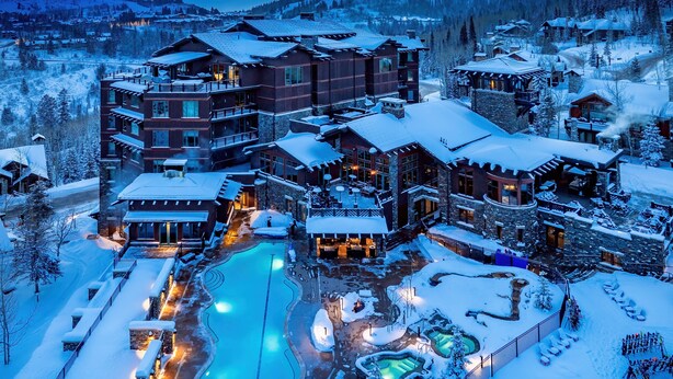 A large resort with multiple buildings, a swimming pool, and snow-covered surroundings. - New Ski-In/Out Ultra Luxe Deer Valley Condo in Intimate Lodge. Superb restaurant (Park City)
