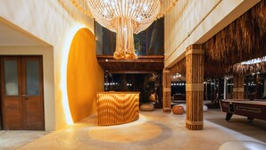 A lobby with a reception desk, a large chandelier, and a pool table. - Sea Sun Bed & Beyond (Koh Samui)
