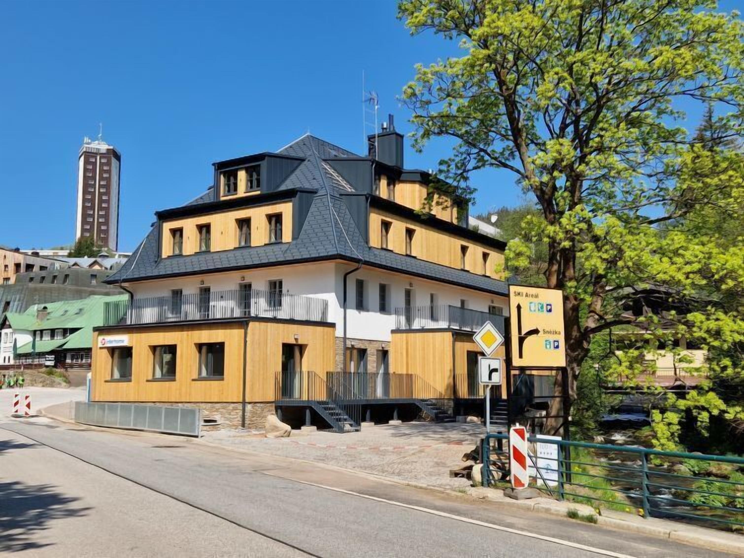 A multi-story building with a modern design, featuring a prominent staircase leading to the upper floors.