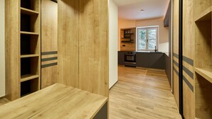 A modern kitchen with wooden cabinetry and a window. - Charming Mountain Oasis by Interhome (Pec pod Snezkou)
