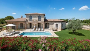 A two-story stone house with a swimming pool, outdoor seating, and a well-maintained garden. - Vacation home Seseli by Interhome (Poreč/Sv. Lovreč)