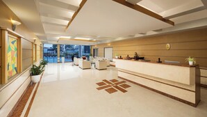 A spacious lobby with a reception desk, seating area, and a large window offering a view of the outdoors. - Fortune Hosur  -  Member ITC Hotels' Group (Hosur)