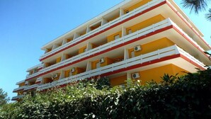 A multi-story building with balconies, likely a hotel or apartment complex.