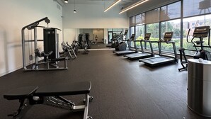 A gym with treadmills, weight machines, and a bench. - Chicago Shared Living Space with Office Space (Chicago)