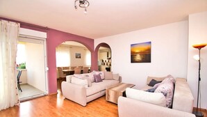 A living room with two sofas, a coffee table, and a painting on the wall. - Villa with amazing sea view, quite area (Krusevo)