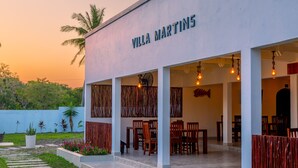 Villa Martins amb zona de pati, mobiliari exterior i camí de jardí.