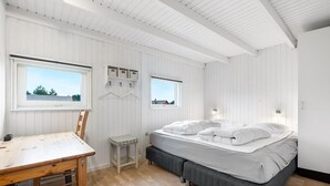 A bedroom with a bed, a desk, and two windows. - "Josef" - 950m from the sea by Interhome (Fanø)