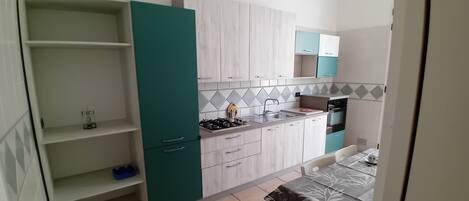 Apartment | Private kitchen | Full-size fridge, oven, stovetop, cookware/dishes/utensils