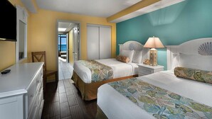 A hotel room with two beds, a TV, a dresser, and a view of the outside. - Astonishing Oceanfront Ste, 9th Flr, Breakfast (Myrtle Beach)