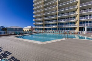 A pool area with a multi-level building in the background.