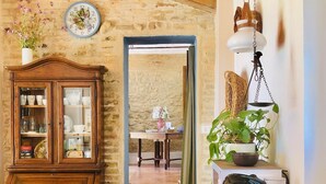 A rustic kitchen with a wooden cabinet, a sink, and a dining table with fresh produce. - Ephemeral - Relaxing Retreat (Abruzzo)