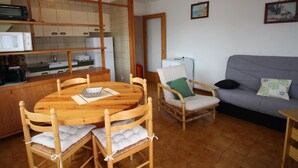 A compact living space with a kitchen, dining area, and seating area.